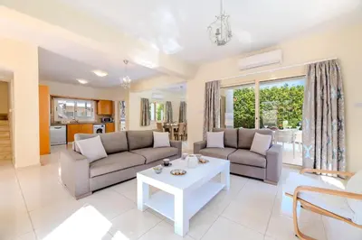 a living room with two couches and a table at Anthorina Greco Villa #10 in Protaras