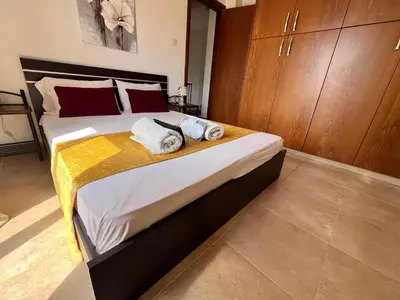 a bedroom with a large bed with towels on it at Villa Callione - Amazing view in Kyperounda
