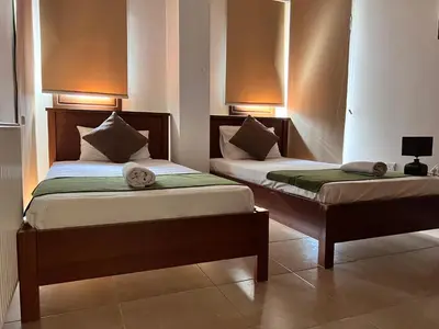 two beds sitting next to each other in a room at Villa Callione - Amazing view in Kyperounda