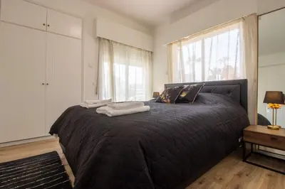 a bedroom with a bed with two towels on it at Modern 2BR Steps from Beach in Voroklini