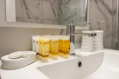 a bathroom sink with a faucet and a group of yellow determs at Modern 2BR Steps from Beach in Voroklini