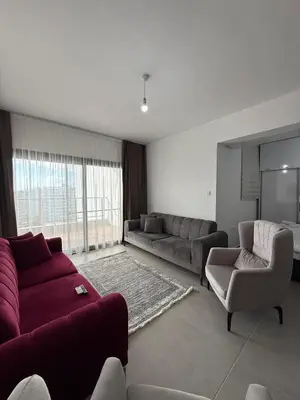 a living room with a couch and chairs and a tv at Caesar Resort & SPA & Apartments Spacious Studio in Avgorou