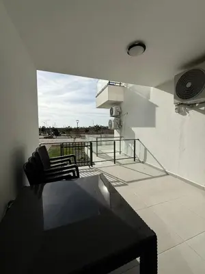 a balcony with two chairs and a table on a building at Caesar Resort & SPA & Apartments Spacious Studio in Avgorou