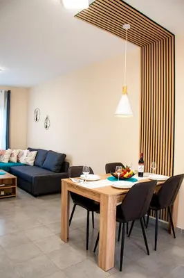 a living room with a table and chairs and a couch at Sunday's Apartment in Paralimni