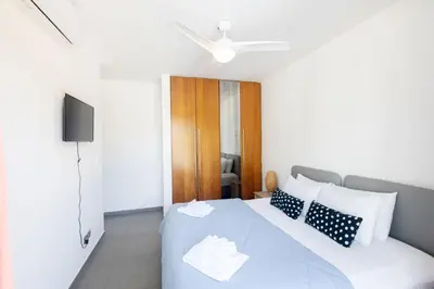 a bedroom with a large white bed with pillows at Ayia Napa Satin Villa SVI1 in Ayia Napa