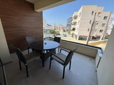 a table and chairs on a balcony with a view at Mordern 2BD APT Perfect for Family or Group in Larnaka