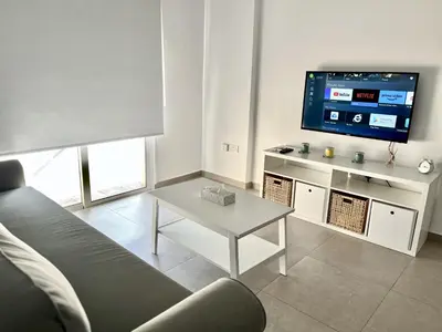 a living room with a couch and a tv at STAY Ease Apartment in Ayia Napa