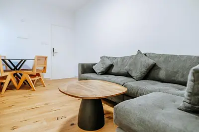 a living room with a couch and a table at Larnaca Beach Bliss Apartment in Larnaka