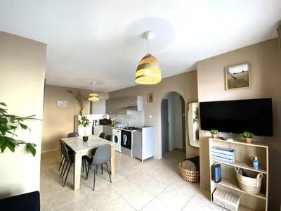 a kitchen and living room with a table and a television at 2 Combined Apts, Fast Wi-Fi, 5 Min Walk to Beach in Larnaka