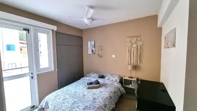 a bedroom with a bed and a window at 2 Cozy Apts, Fast Internet, 5 Min Walk to Beach! in Larnaka