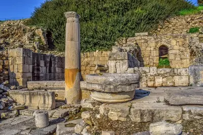 a stone building with a pillar and a stone wall at Amathounta Mare Vista Maison in Limassol