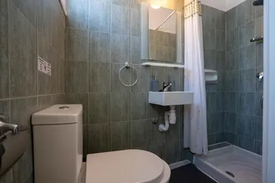 a bathroom with a toilet and a sink and a shower at Charming 3-Bed Duplex with Stunning Sea View in Larnaka