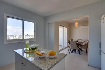 a kitchen with two bowls of fruit on a counter at Charming 3-Bed Duplex with Stunning Sea View in Larnaka