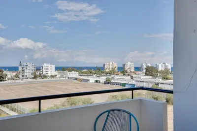 a balcony with a view of a parking lot at Charming 3-Bed Duplex with Stunning Sea View in Larnaka