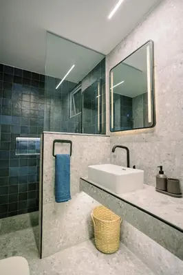 a bathroom with a sink and a mirror at 2BR Amalfi Blue Apt in Larnaca - Pool & 10Min Walk to Mackenzie Beach! in Larnaka