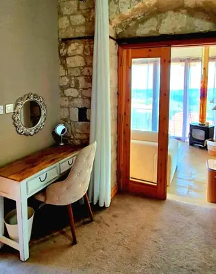 a room with a table and a mirror and a door at Vouno Vouni Cottage in Vouni