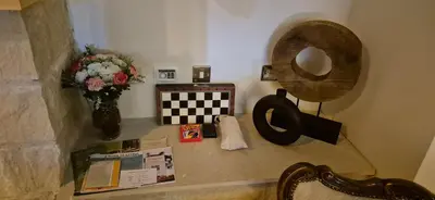 a room with a vase of flowers and a mirror at Vouno Vouni Cottage in Vouni