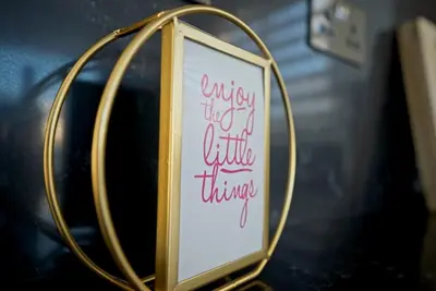 a sign in a gold frame with writing on it at Spacious & Bright 2BR Apartment, 5min to Beach in Boğaz