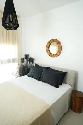 a bedroom with a bed with a mirror on the wall at 4BR BrandNEW LUX Villa Protaras in Paralimni