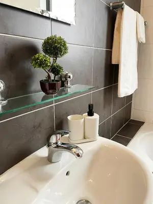 a bathroom sink with two rolls of toilet paper on it at Stylish 2BR Apartment with Balcony and Parking near Saint Lazarus and Finikoudes Beach in Larnaka