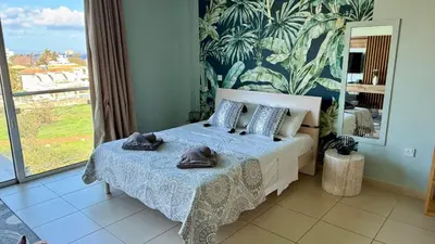 a bedroom with a bed with towels on it at Too Coool Studio Apartment Coralli Resort in Protaras