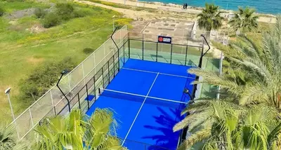 an overhead view of a tennis court next to the beach at Too Coool Studio Apartment Coralli Resort in Protaras