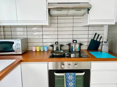 a kitchen with a stove with pots and pans on it at Protaras Cozy2bedroom Apartment in Paralimni