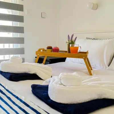 a bed with towels on it with a table on it at Azure Retreat in Ayia Napa