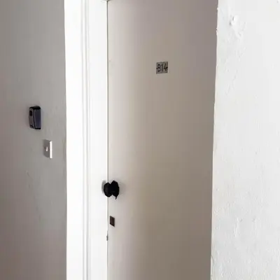 a white door with a sign on it in a room at Azure Retreat in Ayia Napa