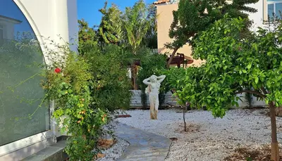 a garden with a statue of a bunny in a yard at Landina villa in Protaras