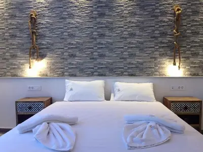 a bedroom with a white bed with towels on it at Advice Deluxe in Nicosia