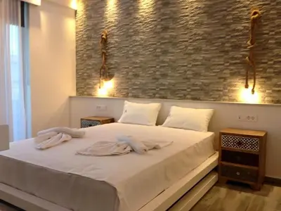 a bedroom with a large white bed with towels on it at Advice Deluxe in Nicosia