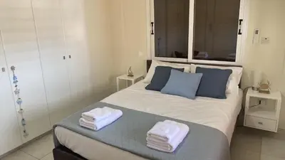 a bedroom with a large bed with towels on it at Celestial Villa in Ayia Napa