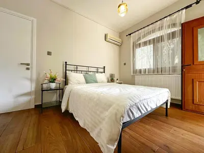 a bedroom with a bed and a window at Cheerful and cozy Bungalow with pool and fireplace in Athalassa