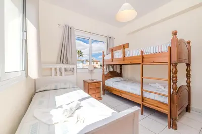 a bedroom with two bunk beds and a window at Marika Heights in Ayia Napa