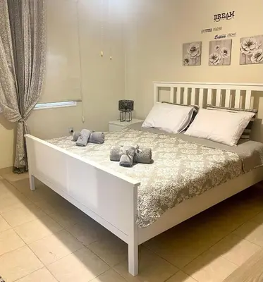 a large white bed with towels on top of it at Charming Oroklini Penthouse with Ocean Views and Private Parking in Voroklini