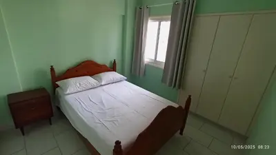 a small bedroom with a bed and a window at Emiliano 7 Holiday Apartment in Larnaka
