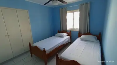 two beds in a blue room with a window at Emiliano 7 Holiday Apartment in Larnaka
