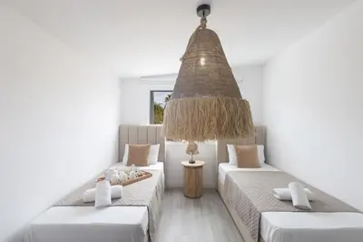 a room with two beds and a chandelier at EvelMar Villa in Protaras
