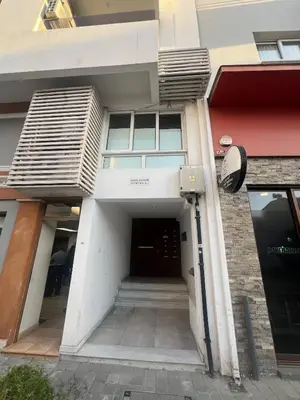 a building with a hallway leading to a door at Sia-Serenity Finikoudes Apartment in Larnaka