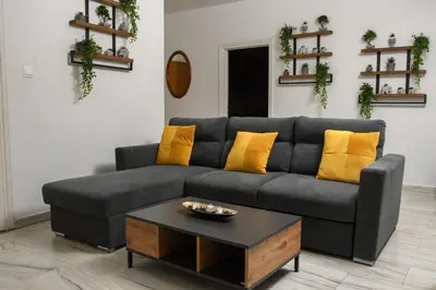 a living room with a gray couch and a coffee table at Ariel 3 bed Apartment in Larnaka