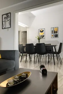 a living room with a table and chairs at Ariel 3 bed Apartment in Larnaka