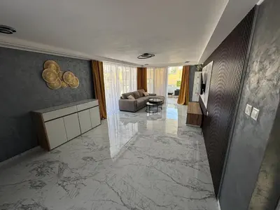 a living room with a marble floor and a couch at Emerald Luxe in Ayia Napa