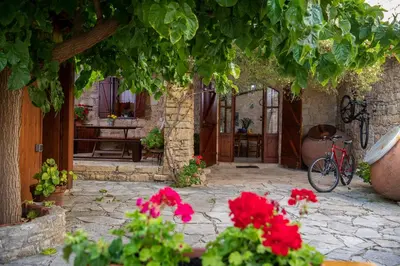 a garden with a bike parked in a courtyard at Apanemia Inn House in Lofou