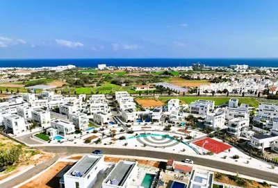 an aerial view of a city with white buildings and the ocean at Villa Camellia - 3bed Bungalow large pool in Protaras