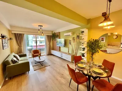 a living room with a table and chairs and a couch at Tropical Cozy 1 - Bedroom Apartment in Limassol