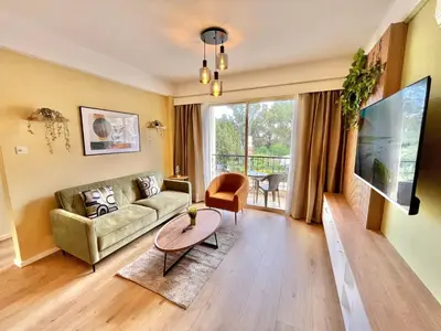 a living room with a couch and a table at Tropical Cozy 1 - Bedroom Apartment in Limassol