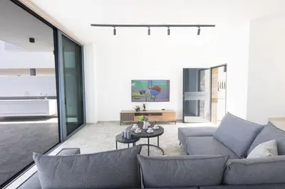 a living room with a couch and a table at Protaras Aqua Villa AQ05 in Protaras