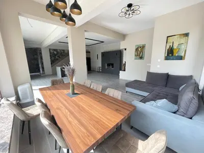 a living room with a wooden table and a couch at Mountain Villa in Prodromos with Fireplace & Sauna in Prodromos