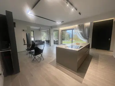 a kitchen and living room with a table and chairs at Mountain Villa in Prodromos with Fireplace & Sauna in Prodromos